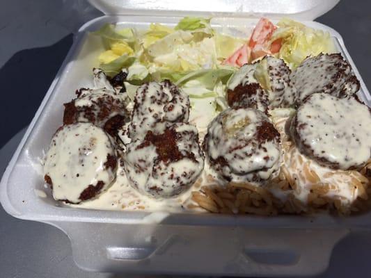 Falafel over rice with eggplant and white sauce