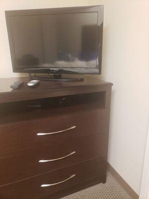 Flat screen TV with DVD player and drawers for personal storage.