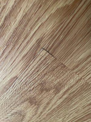 One of the floor boards that is pulling up in another room.