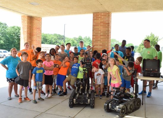 Wow Science campers celebrating completion of robotics week.