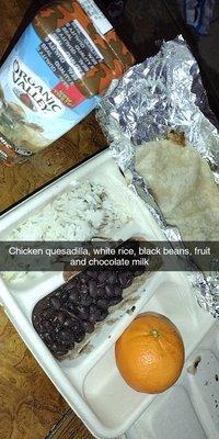 Kids quesadilla meal with black beans, white rice, fruit, and chocolate milk