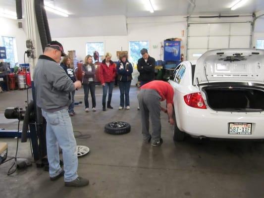 An attendee at out clinic changing a tire