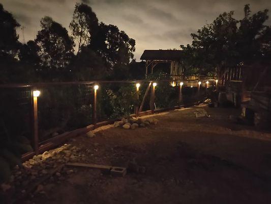 The finished fence with solar post lights.