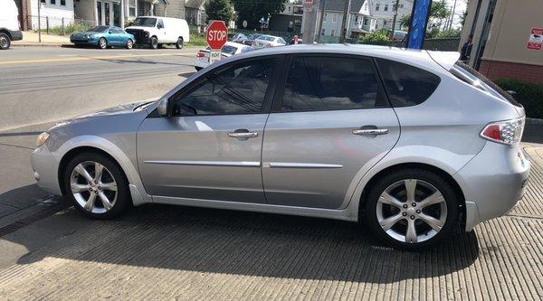 2011 Subaru Outback Impreza with all side windows tinted.