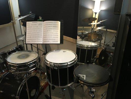 The studio is fully equipped with snare drums, practice pads and 2 full drum kits set up side by side.