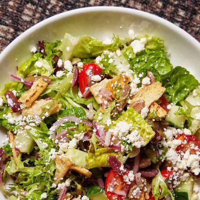 Greek Salad: mixed greens, cucumbers, grape tomatoes, red onions, olives, feta, seasoned pita crisps, greek dressing