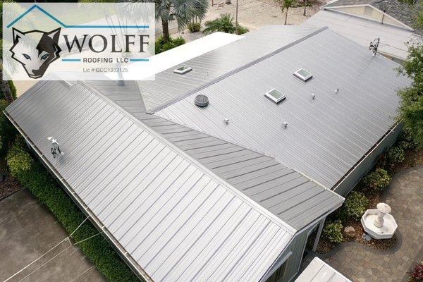 Standing seam metal roof with new skylights and gutters.