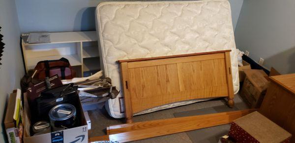 A mattress and deconstructed bed frame, left behind.