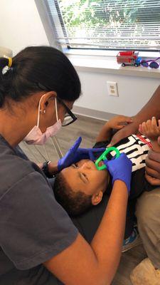 Showing one of our favorite guys, and his mom, how to keep those new teeth clean at home!