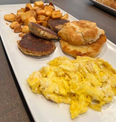 Salmon croquettes, scrambled eggs, home fries and a biscuit