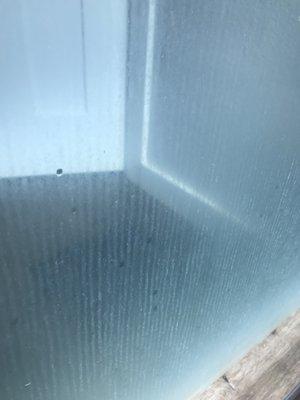 Soap scum build up after application of protective film.