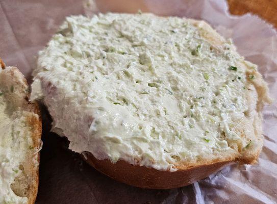 Chive cream cheese on plain bagel