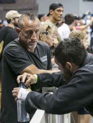 Professor Erik giving Coach Sam some advice between matches at BJJ Tour 2023