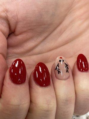 Colorful deep red dipping powder nails with simple nails reindeer design. Cheerful Christmas design.