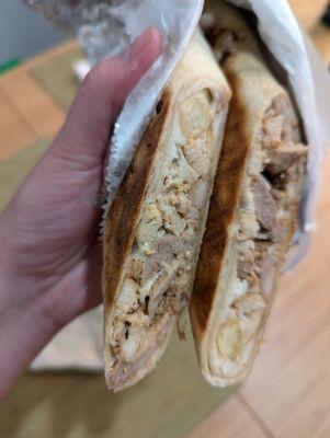 Chicken shawarma wrap- inside is meat, pickles, garlic sauce and fries..bland fries