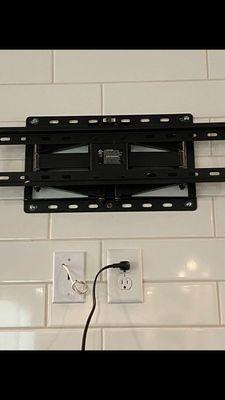 TV mounting bracket on tile backsplash