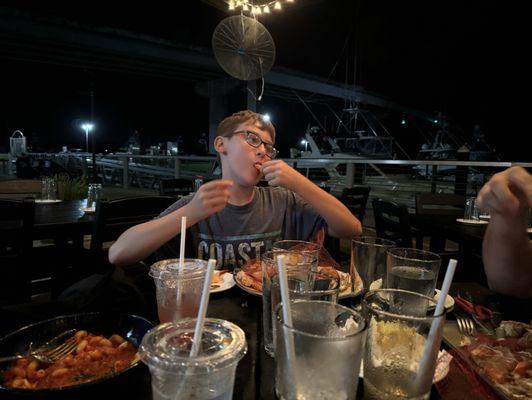 A boy loving his crab legs.