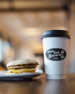 Cup of hot coffee with a breakfast sandwich!