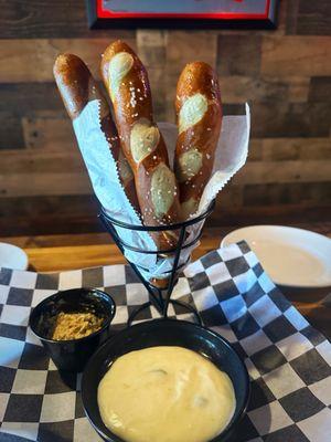 Pretzel sticks with cheese and mustard.