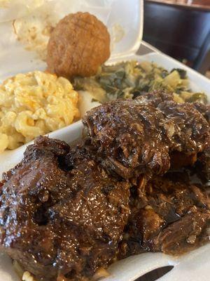 Oxtails, macaroni and cheese, collard greens and cabbage mix