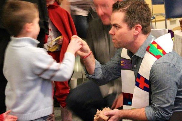 Pastor Adam Phillips serves communion.