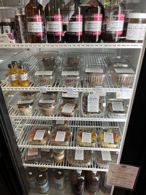 Cold case with raw vegan pies, Chia puddings, fruit, tarts, and other desserts