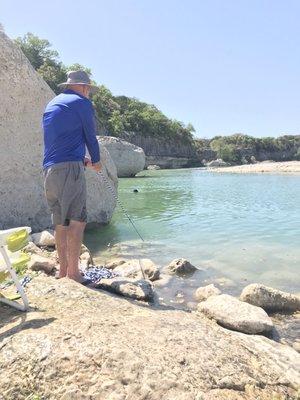 Then a pool area saw fish in but dog scares them away swimming.