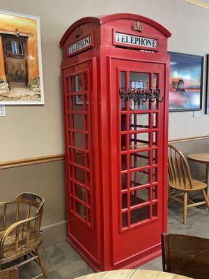 Telephone booth inside art gallery next to the restaurant