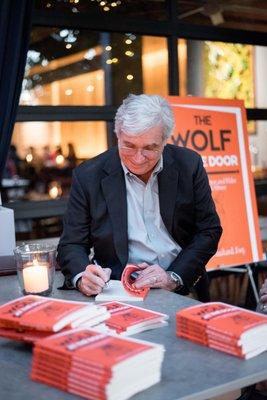 Michael Hackard signs copies of The Wolf at the Door at the official book launch party on Oct. 30th, 2017.