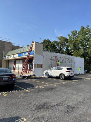 Exterior painting work in progress at New York commercial store