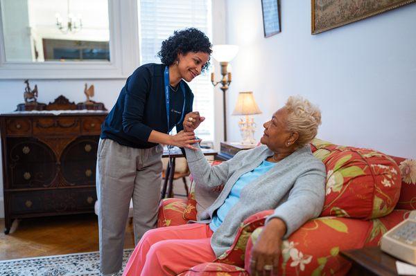 One of our team members helping a patient perform arm exercises.