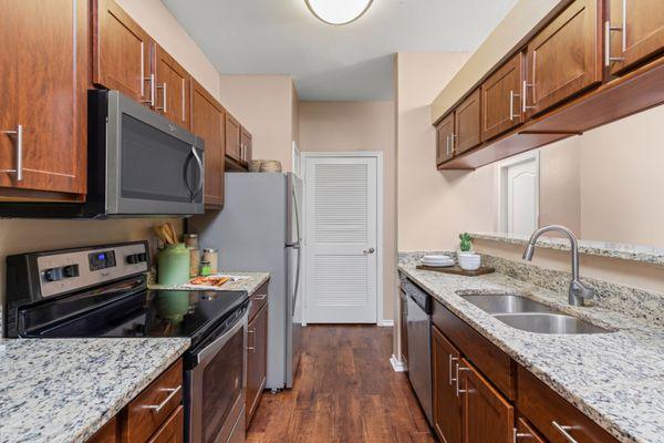 Kitchen with stainless steel appliances at The Springs of Indian Creek