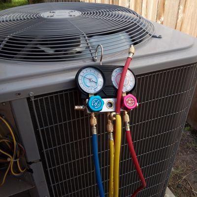 Gauges checking the refrigerant pressures on condenser unit