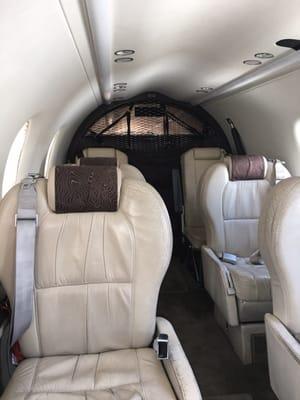 Interior of Boutique's Pilatus PC-12. There are 8 seats in a 1x1 configuration. The four forward seats face each other. Very comfortable.