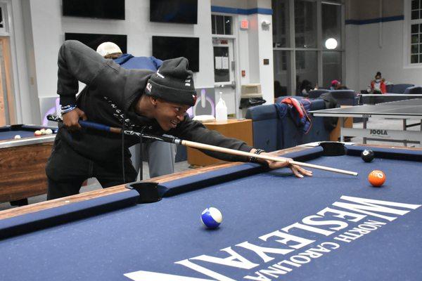 Students playing pool in the Hartness Student Center.