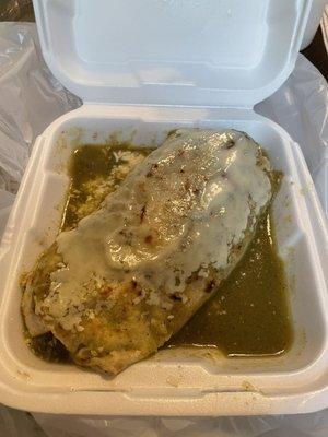 Wet burrito with green sauce topped with cheese!