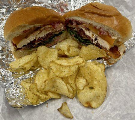 Grilled chicken sandwich with bacon, butternut squash, lettuce, tomato and rosemary and olive oil chips.