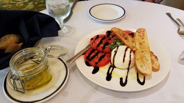 Delicious burrata with tomatoes and parmesan crostini