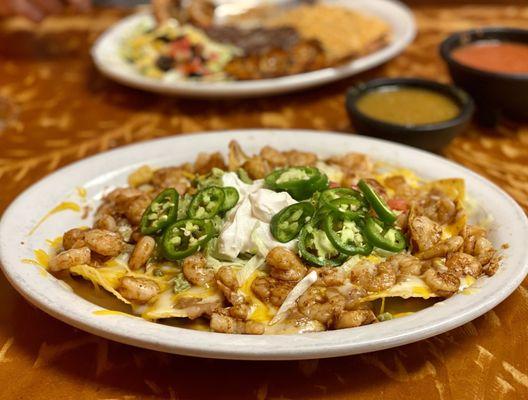 "Grilled Shrimp Nachos" Moi added fresh cut jalapeños. Superb. Can't wait to have these again. Winners circle :)...