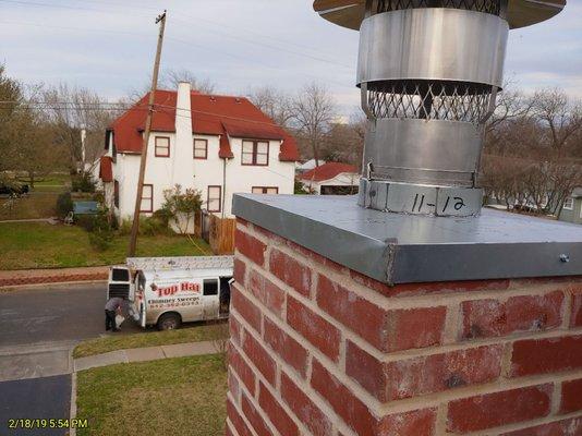 Complete chimney rebuild, with new flue liner, cap rebuilt brick chase after being struck by lightening.