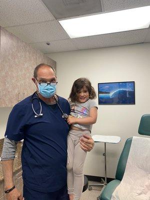 Dr. John and Amélie after she got her lollipops and staple for her cut.