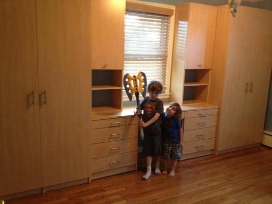 We created a whole wall unit for these boys. With deep hanging sections, shelves, drawers and a desk. they love it!