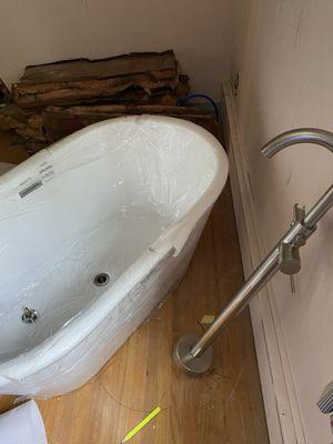 Claw foot tub with floor mount faucet