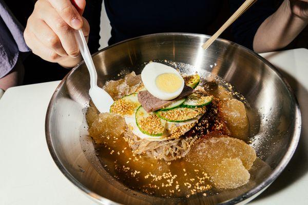 Icy-Spicy - Chilled buckwheat noodles topped with a fruit-bodied gochujang, pickled daikon, fresh cucumber a couple slivers of beef and egg.