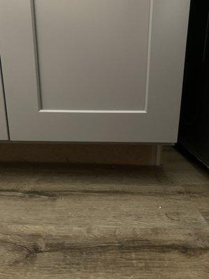 Missing kick plate on laundry room cabinet