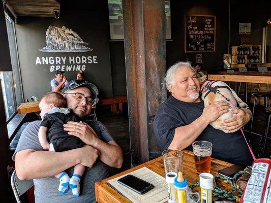 2 dads relaxing 2 babies sleeping at Angry Horse brewery.