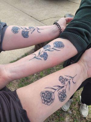 Matching carnation tattoos.