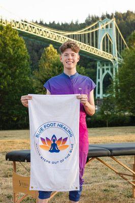 Owner and Practicing LMT Pake R. Nielson. Holding the Blue Foot Healing Logo Flag