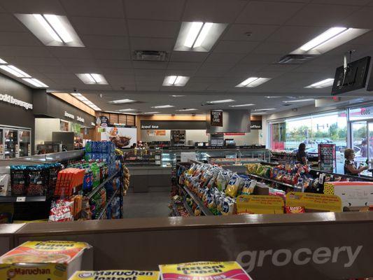 Overall view inside. Lots of different types of food, drinks, sweets, merchandise. Very inviting store design in my opinion.