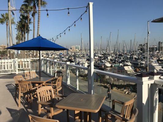 Deck offers shaded seating and panoramic views of the marina and beyond.